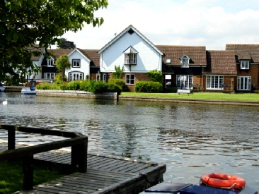 Wherry cottage from across river Bure